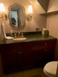 Slide: The Image of Luxurious bathroom on 2015 Broward Raised Pilothouse M/Y yacht with elegant fixtures and mirror. - 38