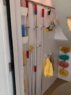 Slide: The Image of Cleaning supplies neatly organized in a storage area on a 2015 Broward Raised Pilothouse M/Y yacht. - 47