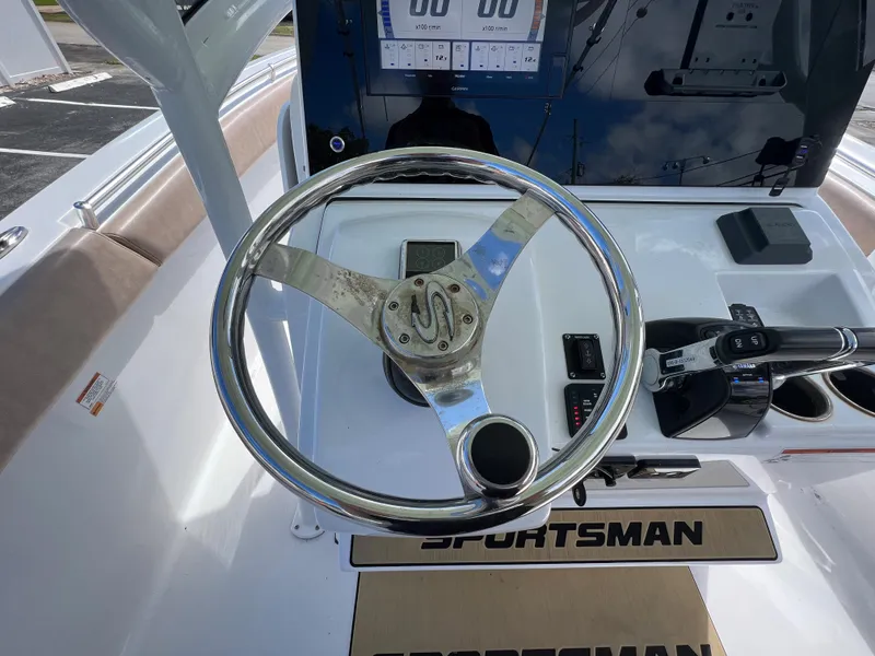 Slide: The Image of 2020 Sportsman Heritage 251 Center Console boat steering wheel and control panel. - 10