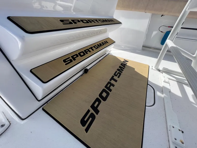 Slide: The Image of 2020 Sportsman Heritage 251 Center Console boat steps and deck with branded mats. - 18