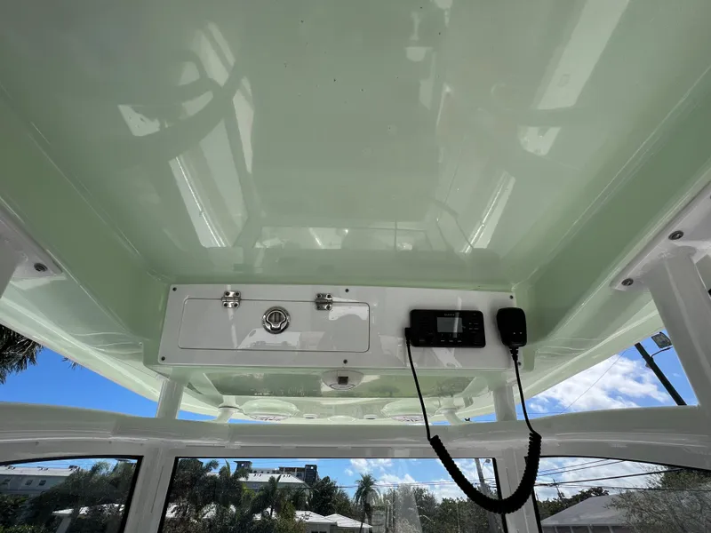 Slide: The Image of 2020 Sportsman Heritage 251 Center Console boat interior roof with storage and electronics. - 19