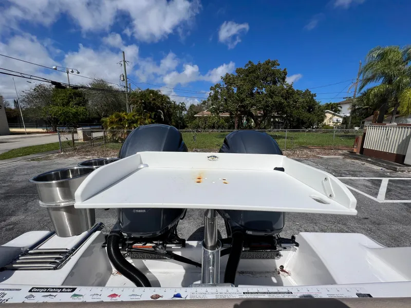 Slide: The Image of 2020 Sportsman Heritage 251 Center Console boat with dual engines and a clean deck. - 26