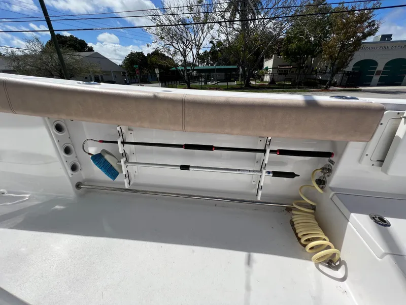 Slide: The Image of 2020 Sportsman Heritage 251 Center Console boat interior with rod holders and hose. - 31