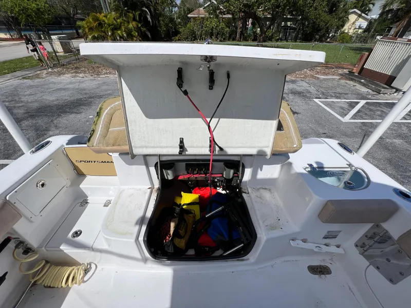 Slide: The Image of 2020 Sportsman Heritage 251 Center Console boat storage compartment open. - 32