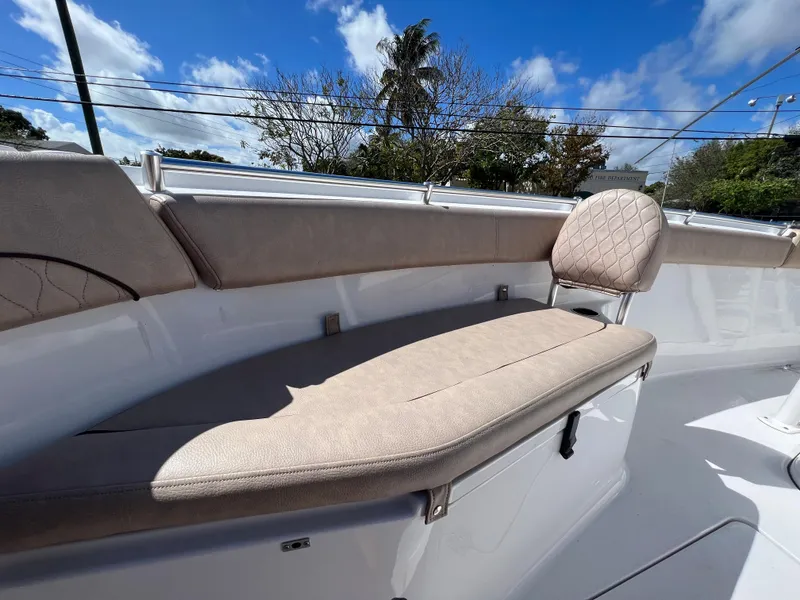 Slide: The Image of 2020 Sportsman Heritage 251 Center Console boat with cushioned seating under a blue sky. - 44