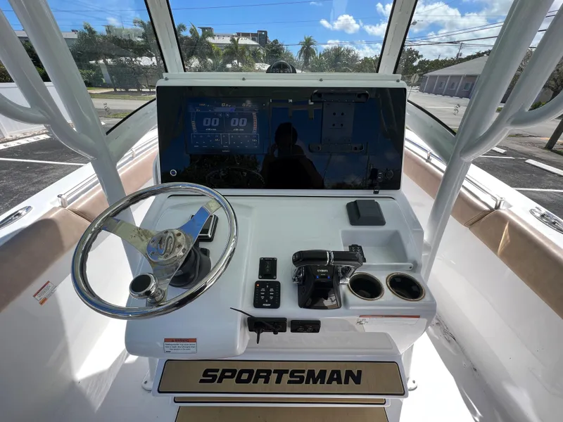 Slide: The Image of 2020 Sportsman Heritage 251 Center Console boat dashboard with steering wheel and controls. - 9
