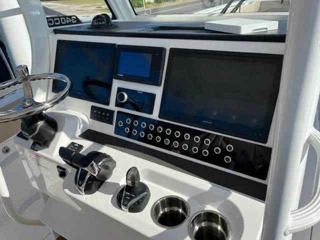 Slide: The Image of 2023 Edgewater 340CC boat dashboard with advanced navigation and control systems. - 15
