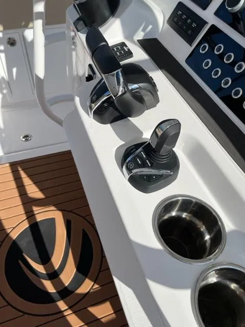Slide: The Image of Edgewater 340CC 2023 boat control panel with joystick and throttle. - 16