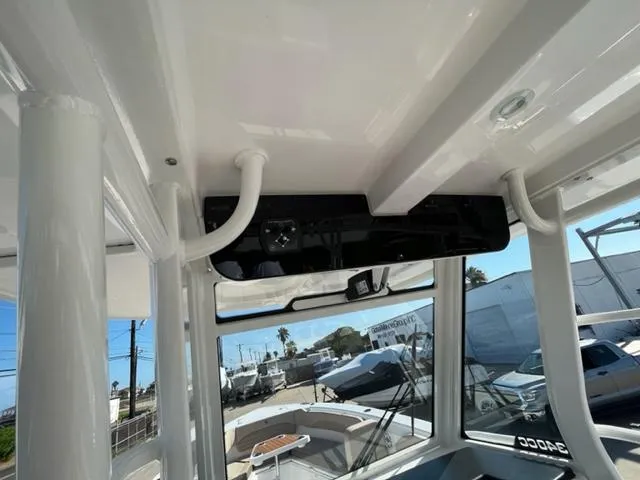 Slide: The Image of 2023 Edgewater 340CC boat interior with overhead console and windows. - 19