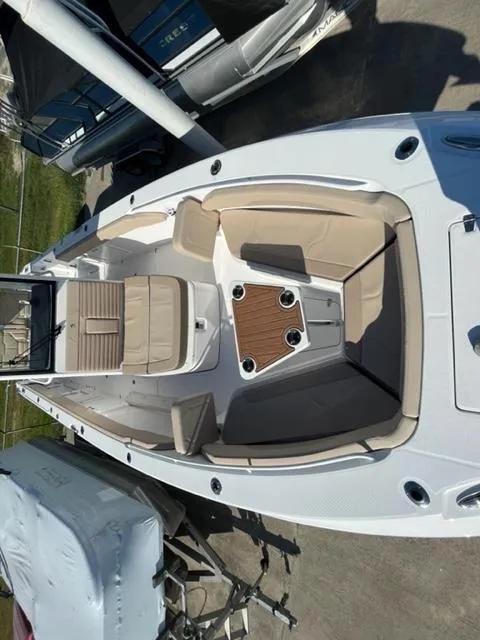 Slide: The Image of 2023 Edgewater 340CC boat with beige seating and wooden table. - 20