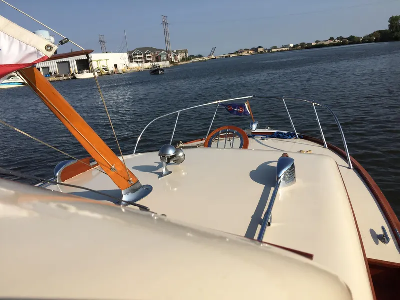 Slide: The Image of 1954 Chris-Craft Commander boat on calm water, showcasing classic design and craftsmanship. - 11