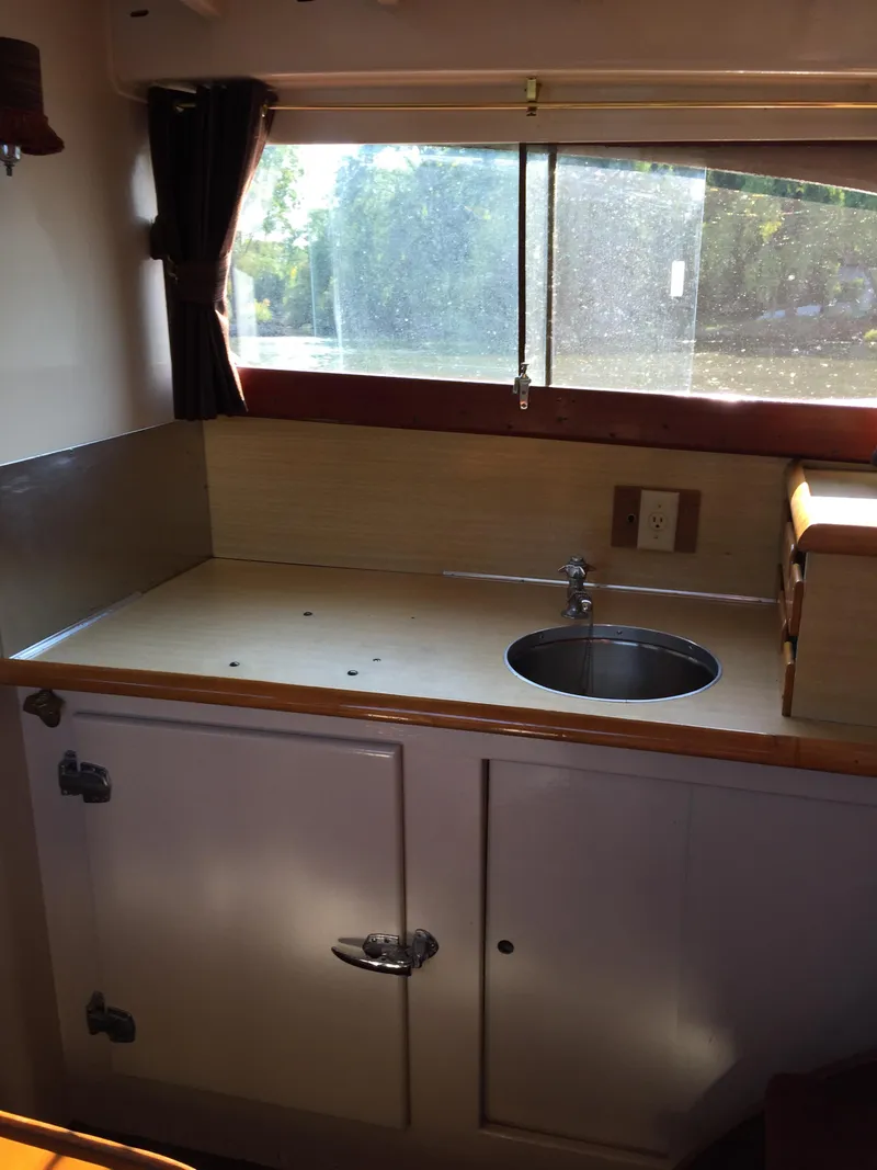 Slide: The Image of 1954 Chris-Craft Commander kitchen area with sink and window view. - 16
