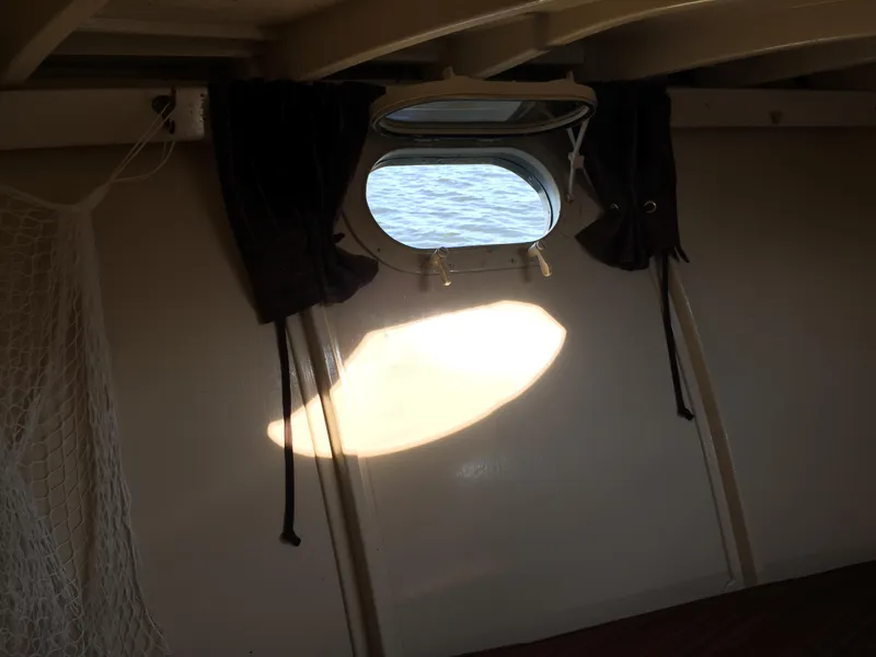 Slide: The Image of 1954 Chris-Craft Commander interior with porthole view of the sea. - 19