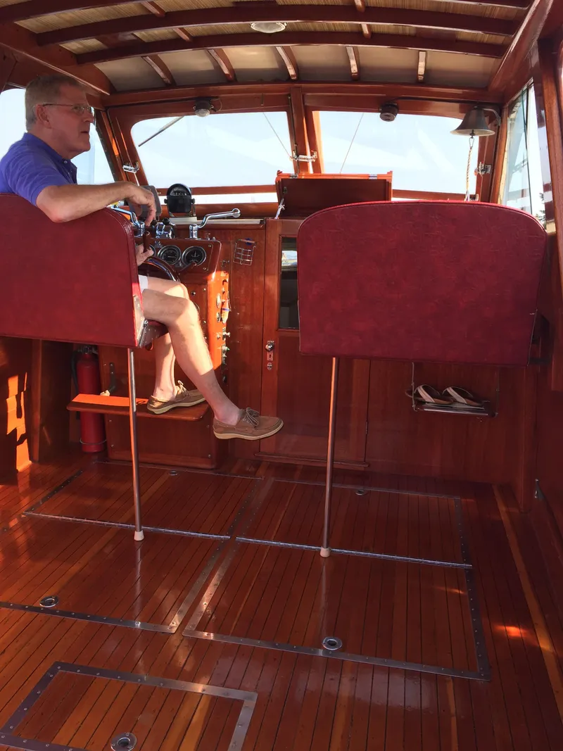 Slide: The Image of 1954 Chris-Craft Commander interior with wooden finish and red seating. - 26