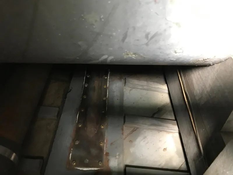 Slide: The Image of Interior view of a 1954 Chris-Craft Commander boat, showcasing metal components and rivets. - 27