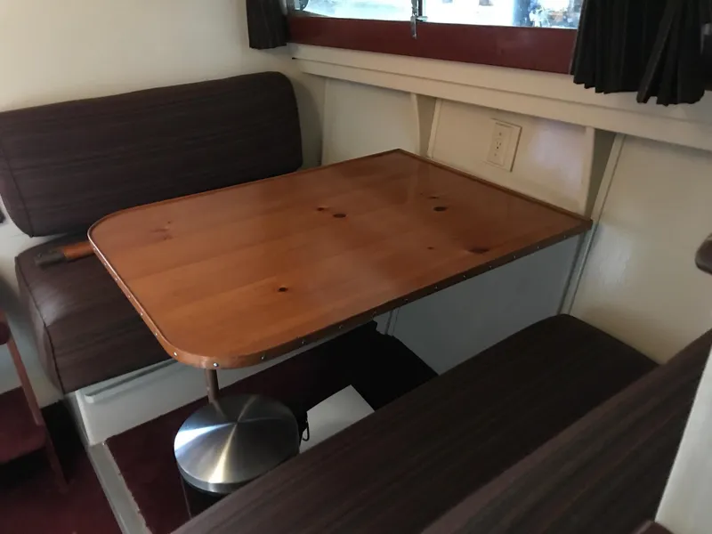 Slide: The Image of 1954 Chris-Craft Commander interior with wooden table and cushioned seating. - 29