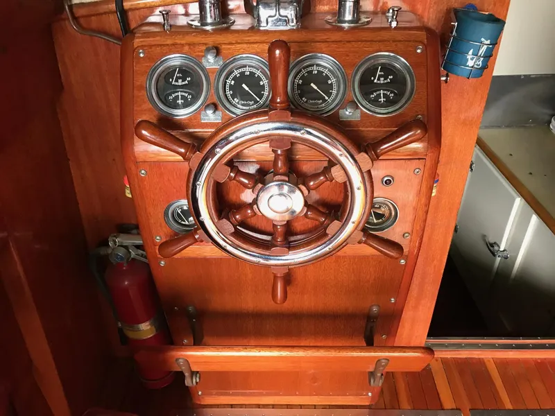 Slide: The Image of 1954 Chris-Craft Commander wooden helm with gauges and steering wheel. - 32