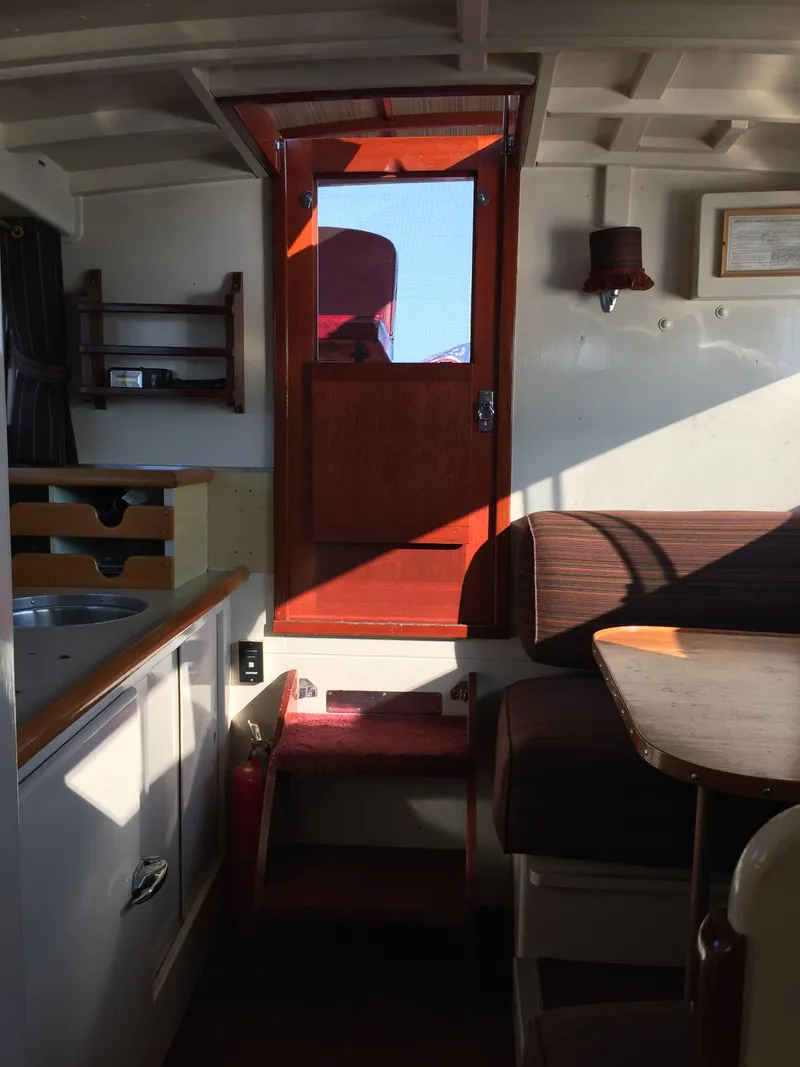 Slide: The Image of Interior of a 1954 Chris-Craft Commander boat, featuring wooden accents and seating area. - 4