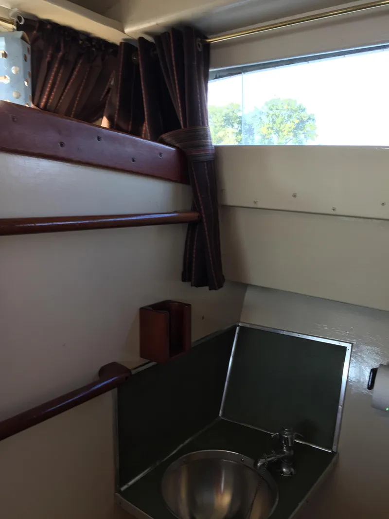 Slide: The Image of 1954 Chris-Craft Commander interior with sink, window, and curtains. - 5