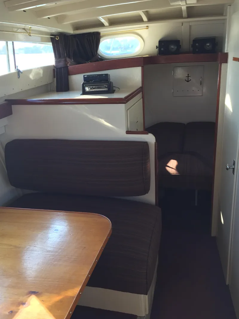 Slide: The Image of 1954 Chris-Craft Commander interior with wood accents and cozy seating area. - 7