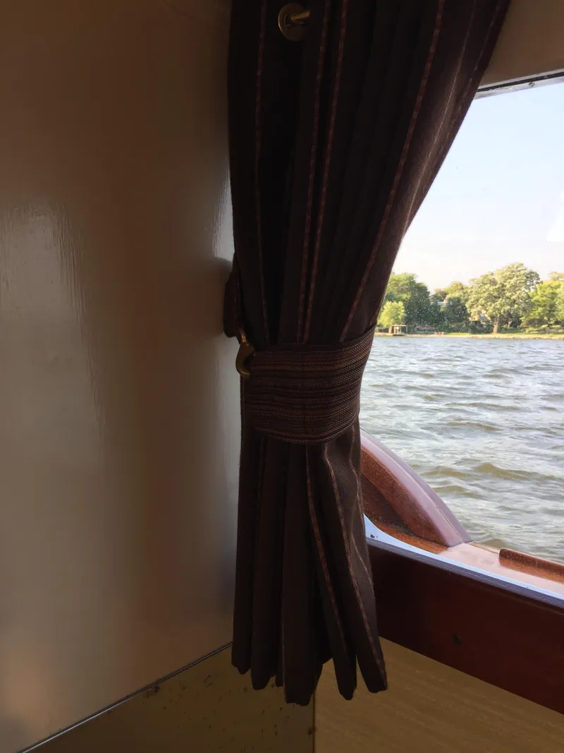 Slide: The Image of 1954 Chris-Craft Commander boat interior with window view of water and trees. - 8