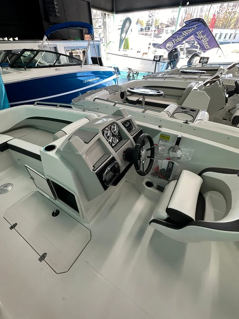 Slide: The Image of 2025 Starcraft SVX 211 OB boat interior with modern dashboard and seating. - 11