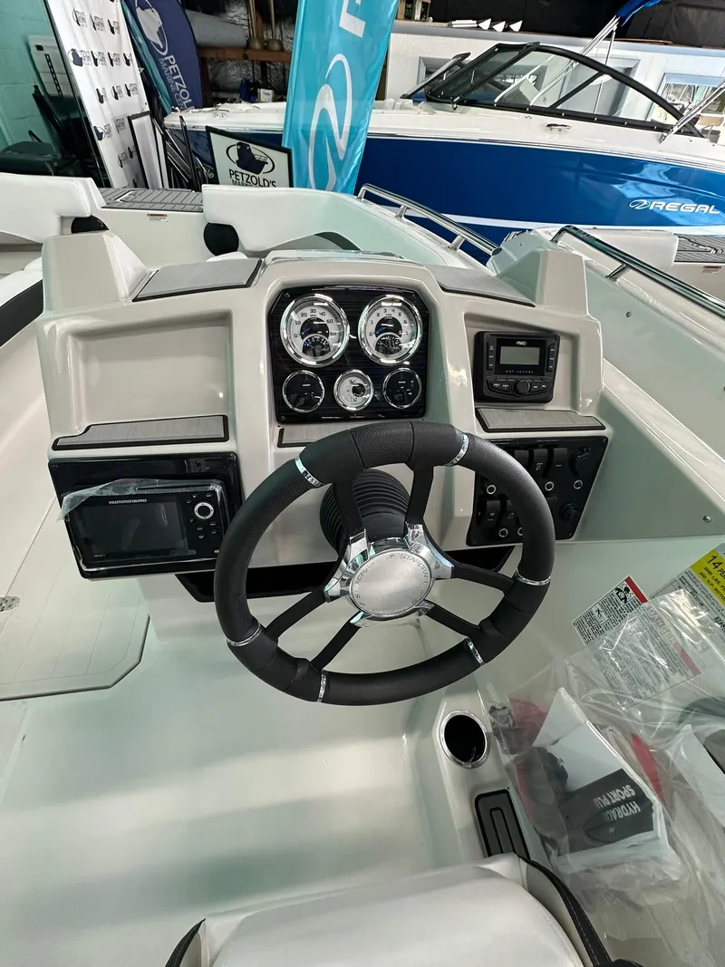 Slide: The Image of 2025 Starcraft SVX 211 OB boat interior with seating and storage compartments. - 12