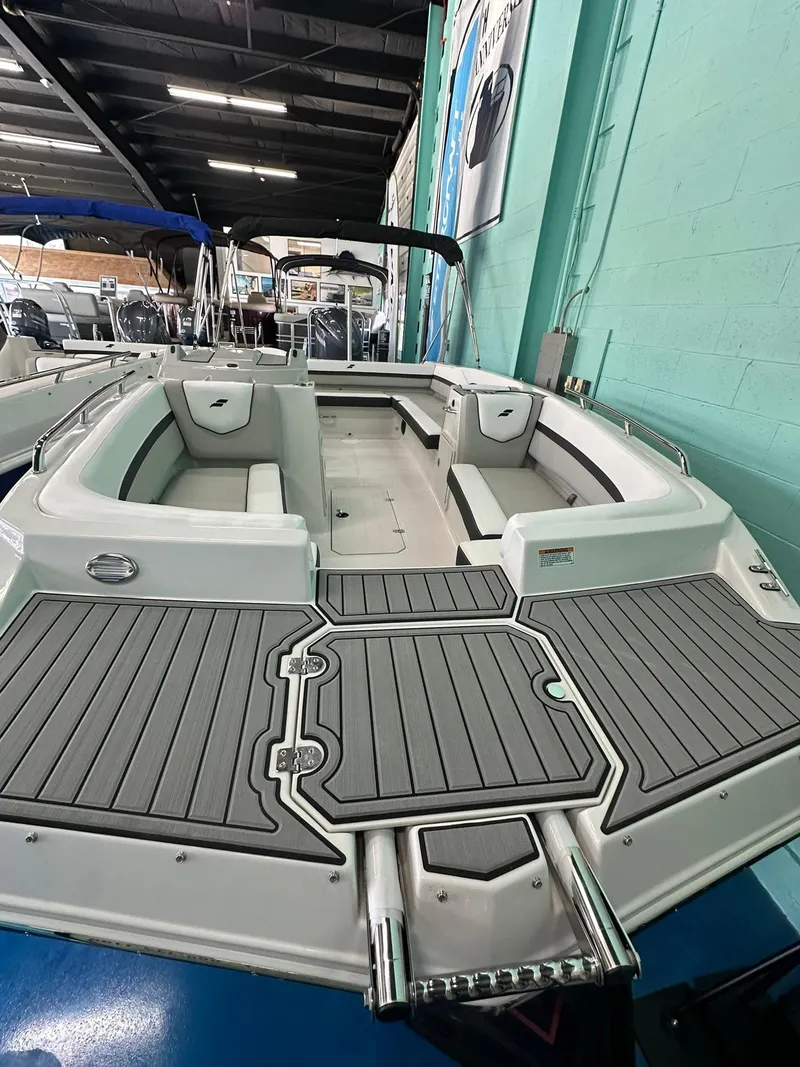 Slide: The Image of 2025 Starcraft SVX 211 OB boat with spacious seating and modern design in showroom. - 17