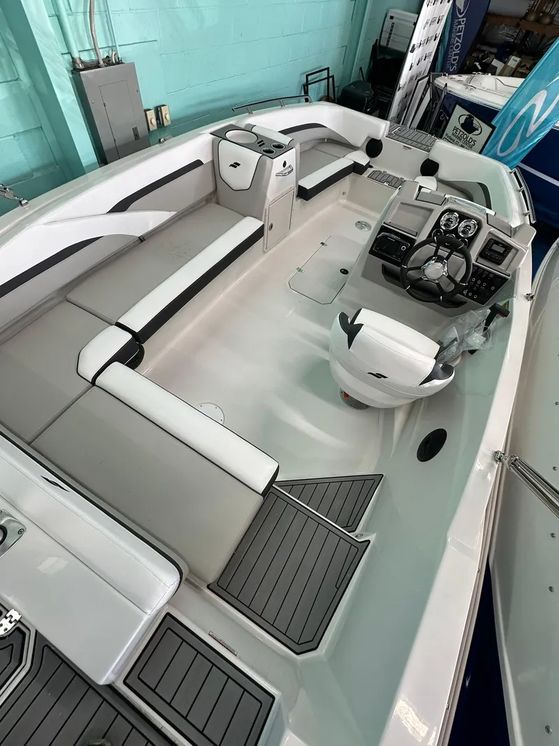 Slide: The Image of 2025 Starcraft SVX 211 OB boat with Yamaha engine, showcased indoors. - 7