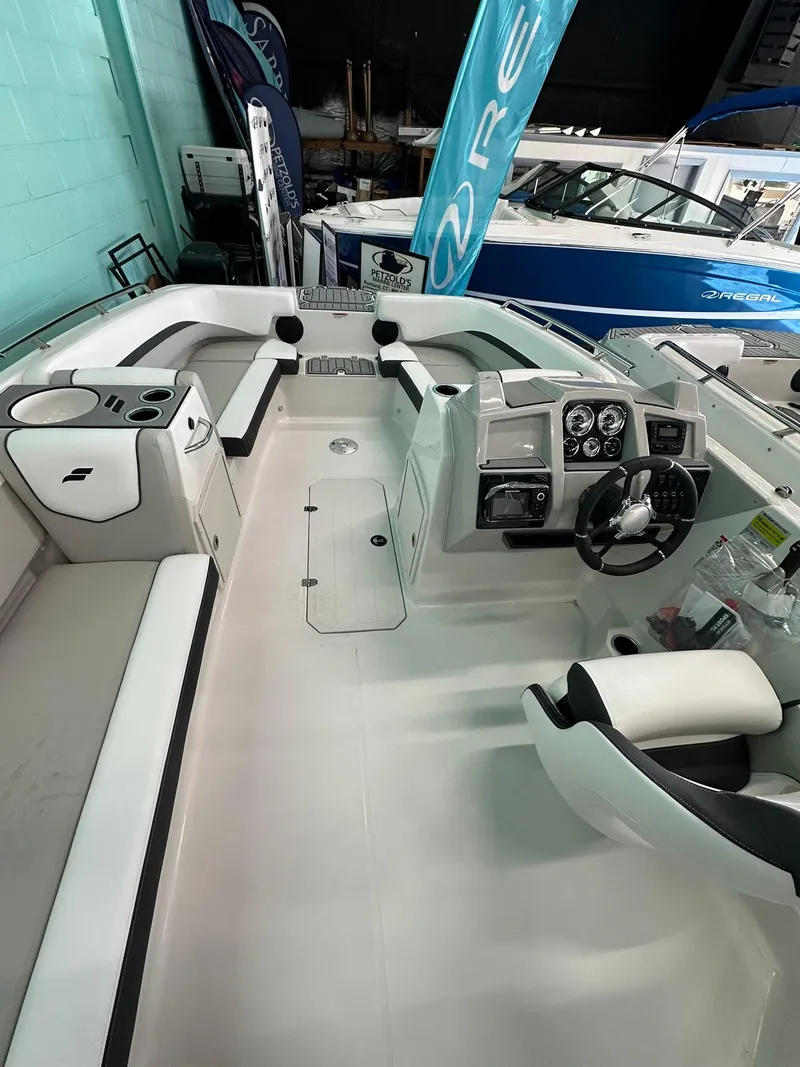 Slide: The Image of 2025 Starcraft SVX 211 OB boat interior with modern seating and control panel. - 9