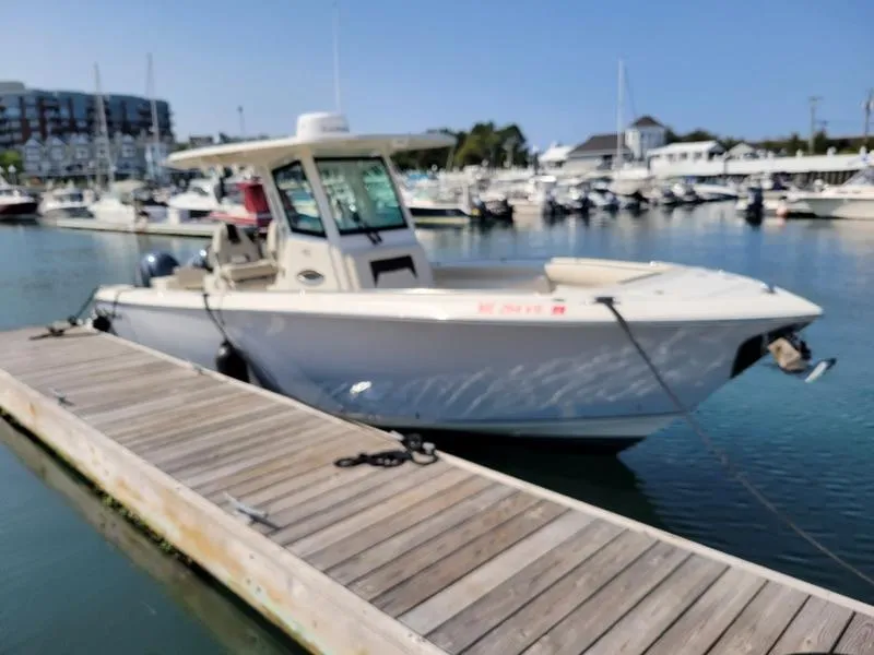 Slide: The Image of 2023 Sailfish 272 CC boat docked at marina. - 1