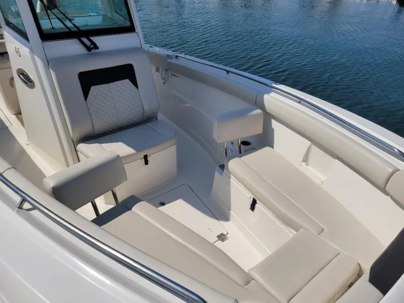 Slide: The Image of 2023 Sailfish 272 CC boat interior with cushioned seating and sleek design. - 10