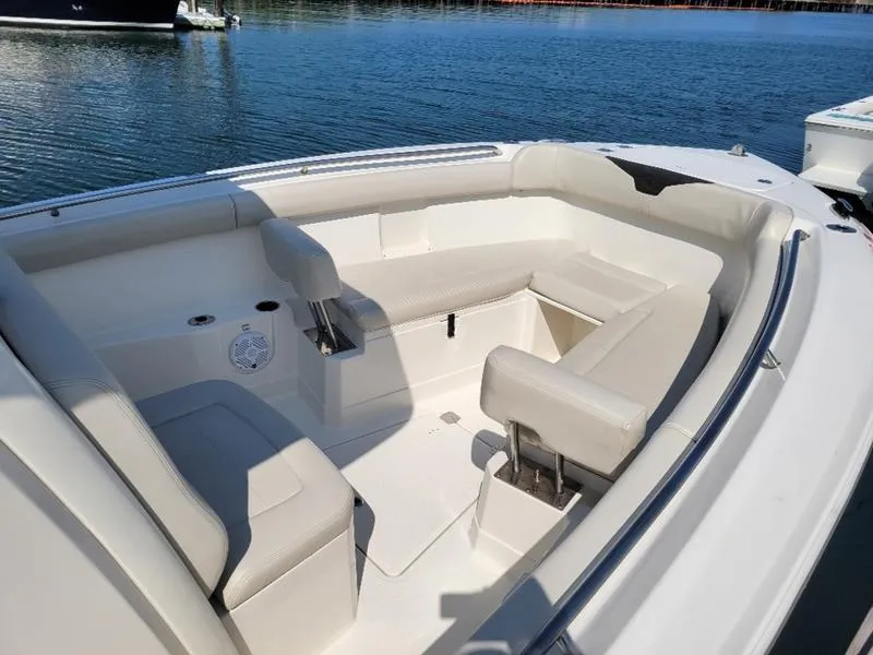 Slide: The Image of 2023 Sailfish 272 CC boat interior with cushioned seating on calm water. - 13