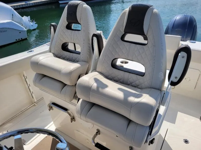 Slide: The Image of Luxurious seating on 2023 Sailfish 272 CC boat, featuring quilted upholstery and ergonomic design. - 2