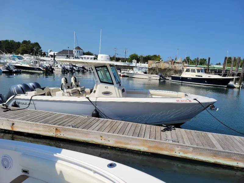 Slide: The Image of 2023 Sailfish 272 CC boat docked at marina under clear blue sky. - 3