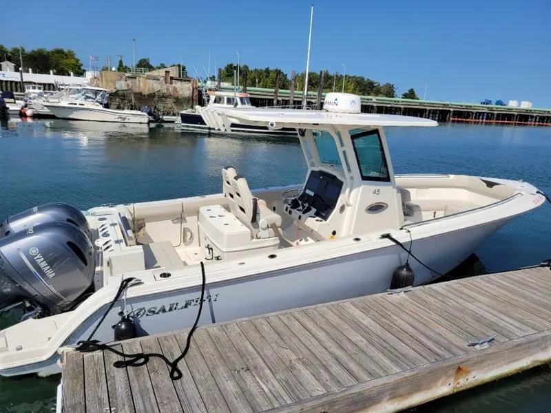 Slide: The Image of 2023 Sailfish 272 CC boat docked in a marina with Yamaha outboard motor. - 4