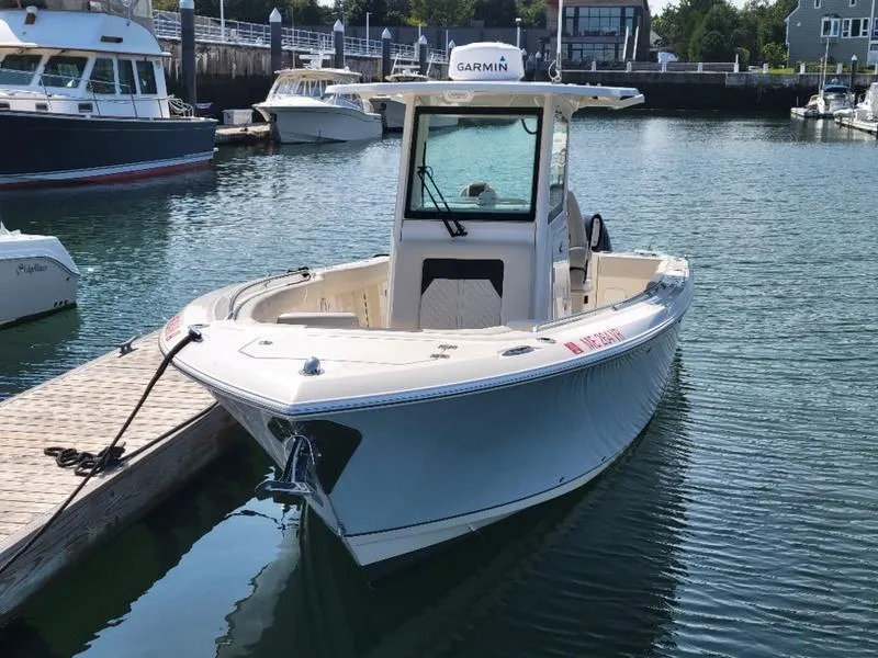 Slide: The Image of 2023 Sailfish 272 CC boat docked in a marina, featuring Garmin equipment. - 5