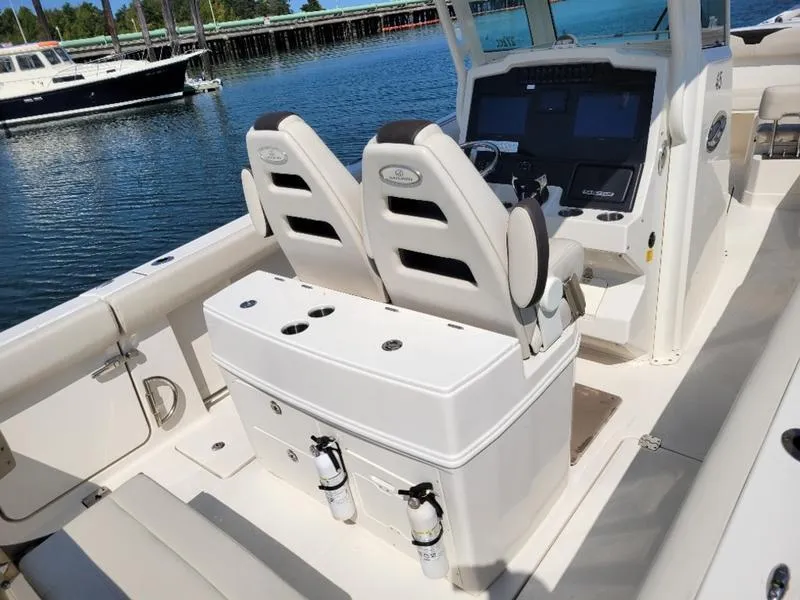 Slide: The Image of 2023 Sailfish 272 CC boat interior with dual seats and control panel. - 8