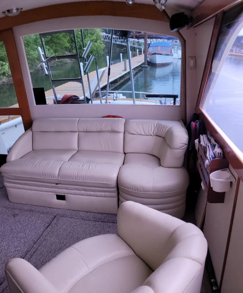 Slide: The Image of Interior of 1983 Ocean Yachts Super Sport with beige leather seating and marina view. - 11