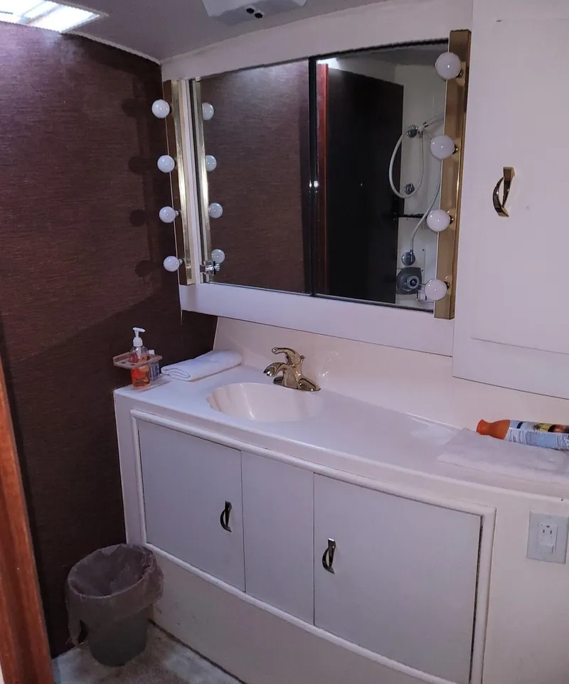 Slide: The Image of 1983 Ocean Yachts Super Sport bathroom with vanity, mirror, and lighting. - 16