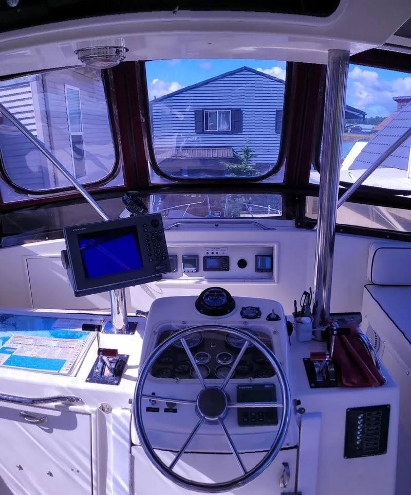 Slide: The Image of 1983 Ocean Yachts Super Sport boat helm with navigation equipment and steering wheel. - 17