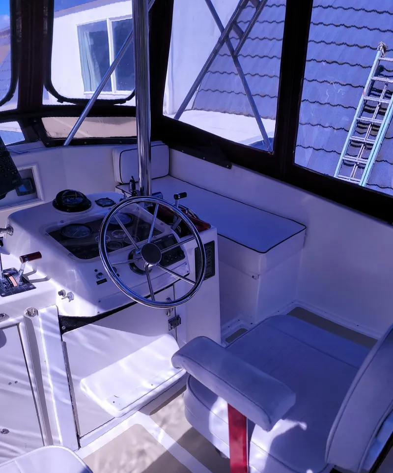 Slide: The Image of 1983 Ocean Yachts Super Sport boat interior with steering wheel and seating. - 19