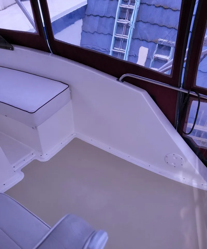 Slide: The Image of 1983 Ocean Yachts Super Sport interior with white seating and windows. - 22