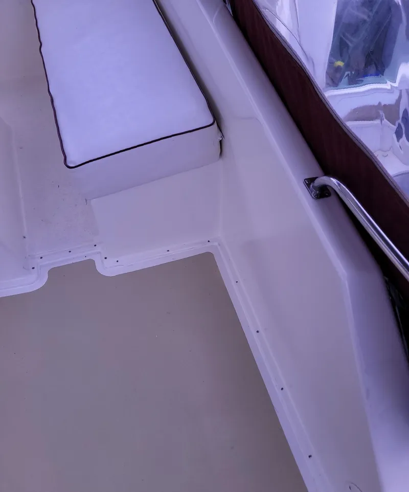Slide: The Image of 1983 Ocean Yachts Super Sport boat interior with white seating and railing. - 23