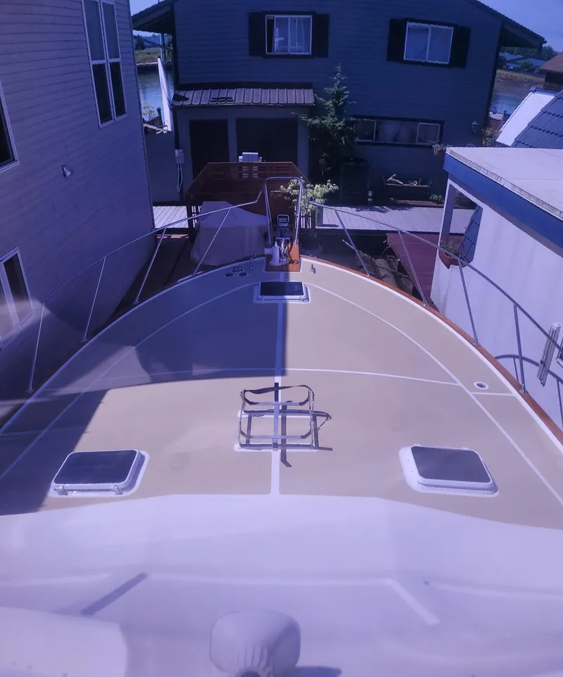 Slide: The Image of 1983 Ocean Yachts Super Sport boat docked between houses. - 24