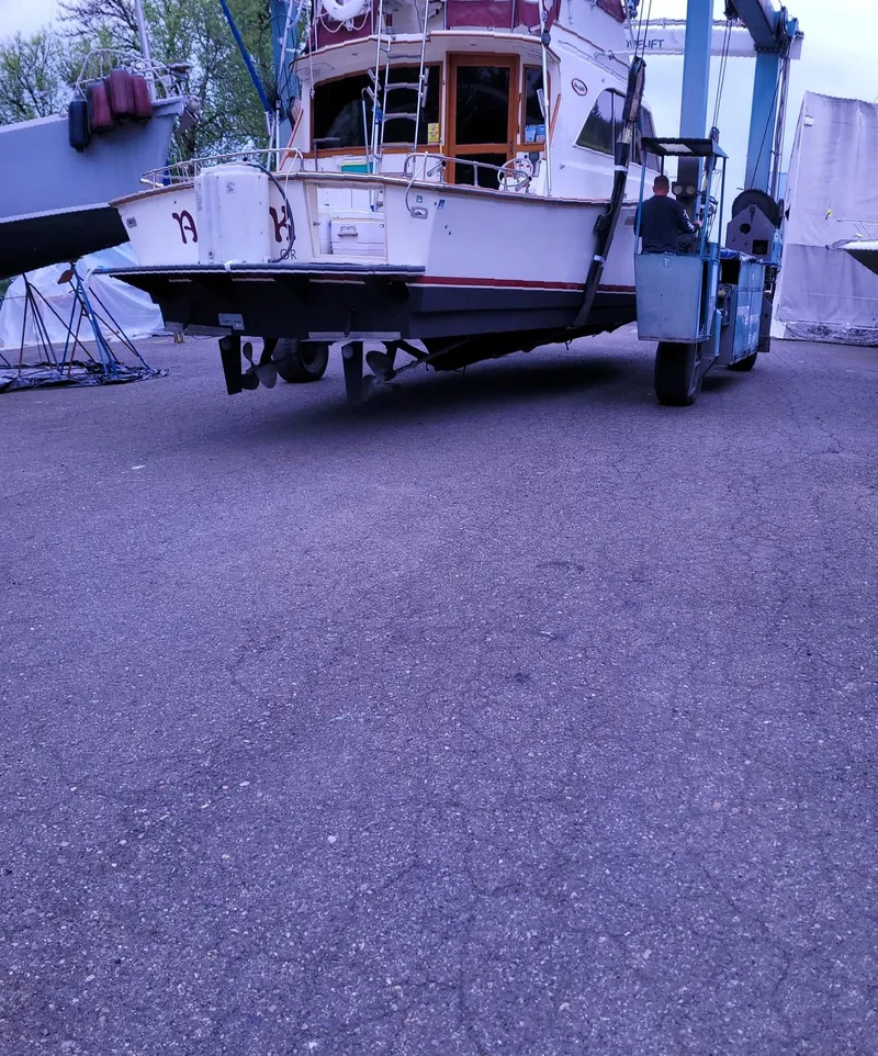 Slide: The Image of 1983 Ocean Yachts Super Sport boat being lifted for maintenance. - 3