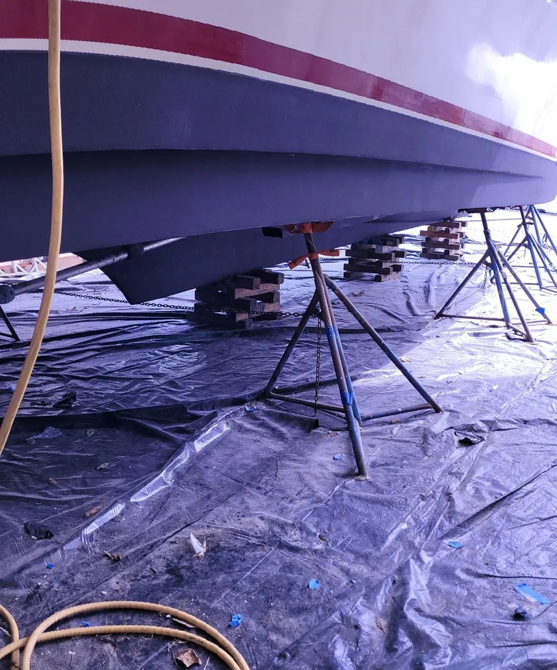 Slide: The Image of 1983 Ocean Yachts Super Sport boat hull on stands for maintenance. - 31