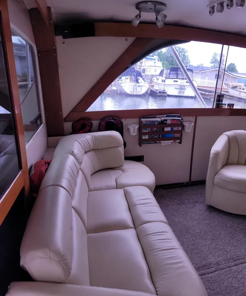 Slide: The Image of Interior of 1983 Ocean Yachts Super Sport with leather seating and marina view. - 5