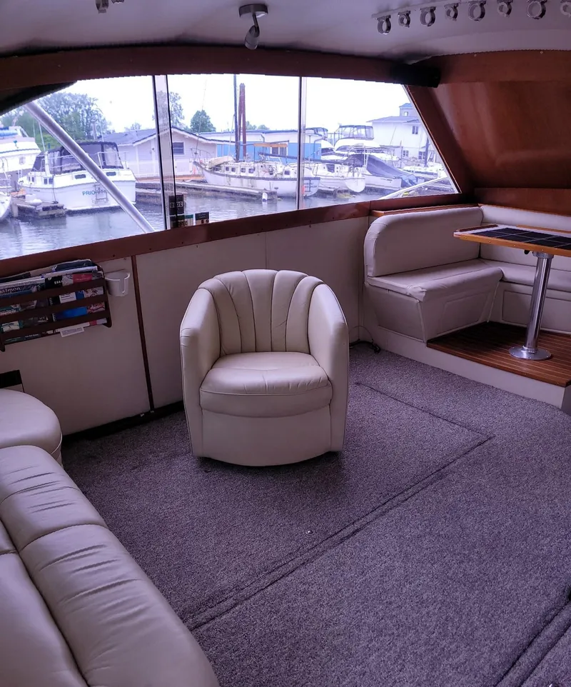 Slide: The Image of Interior of 1983 Ocean Yachts Super Sport with leather seating and marina view. - 6