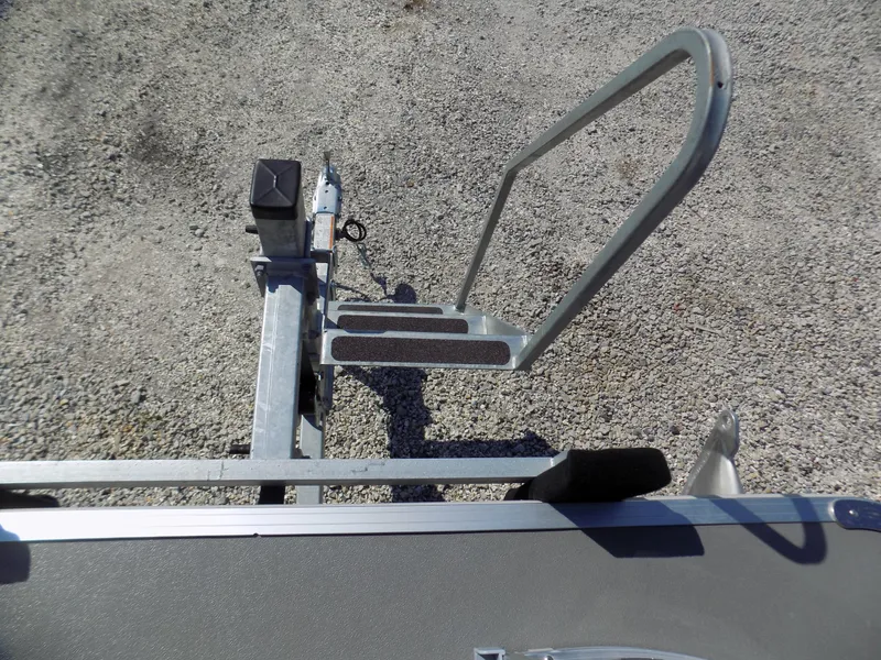 Slide: The Image of 2022 Sylvan Mirage Fish 8522 Party Fish boat trailer step on gravel surface. - 13